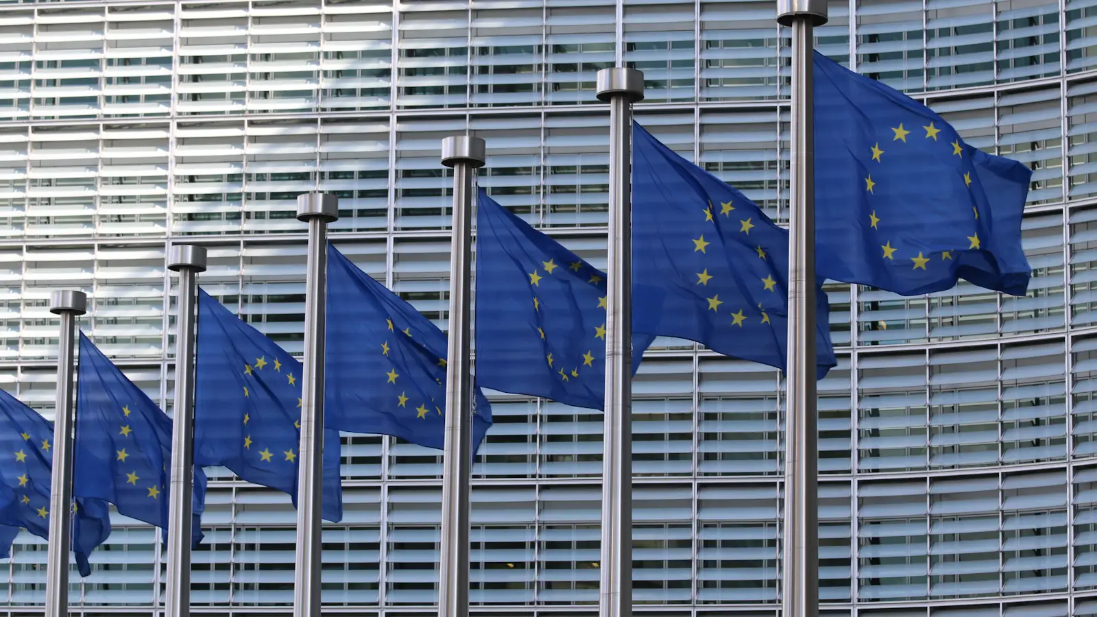 Reihe von EU-Flaggen vor dem Berlaymont-Gebäude in Brüssel